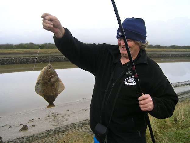 an angler with a River Arun flounder