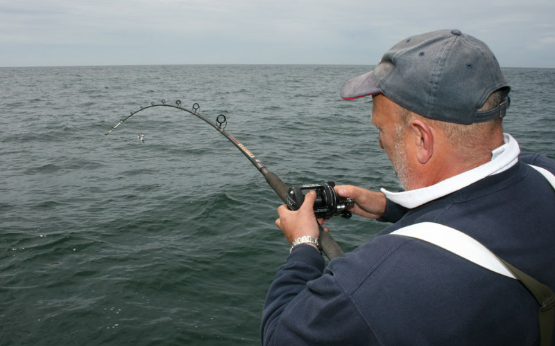 an angler enjoys a day on a charter boat