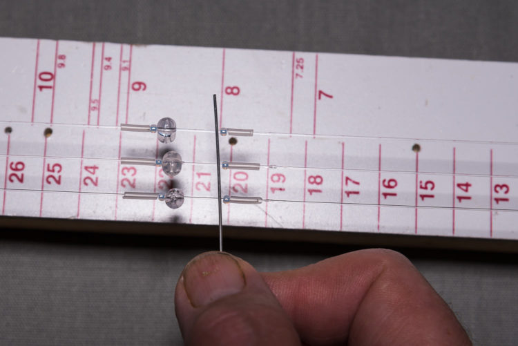 Push the tubing away from the two-way bead and over the glue