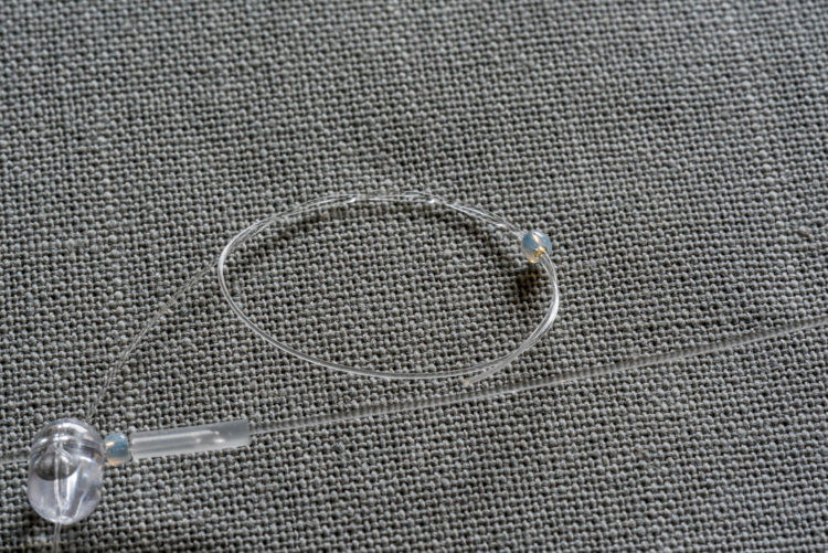 Snood tail knot over micro bead