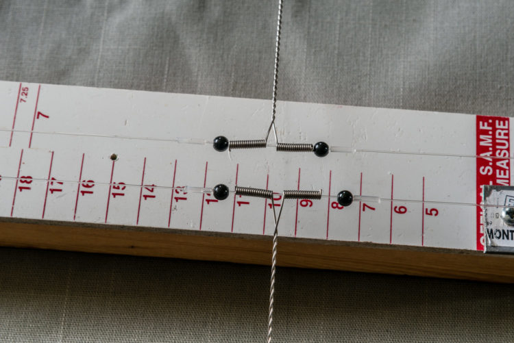 Wire booms located using glued stops