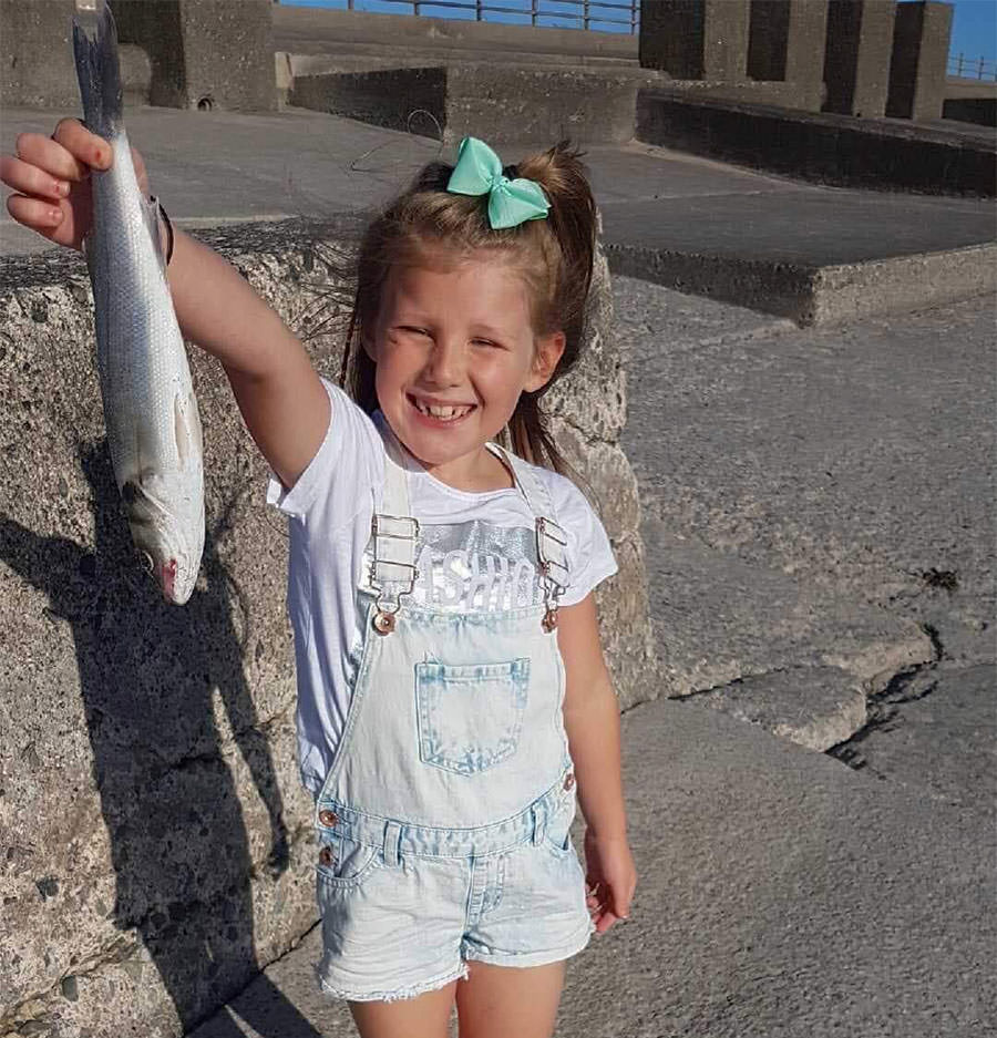 8 year old Emily Walls with her first ever fish