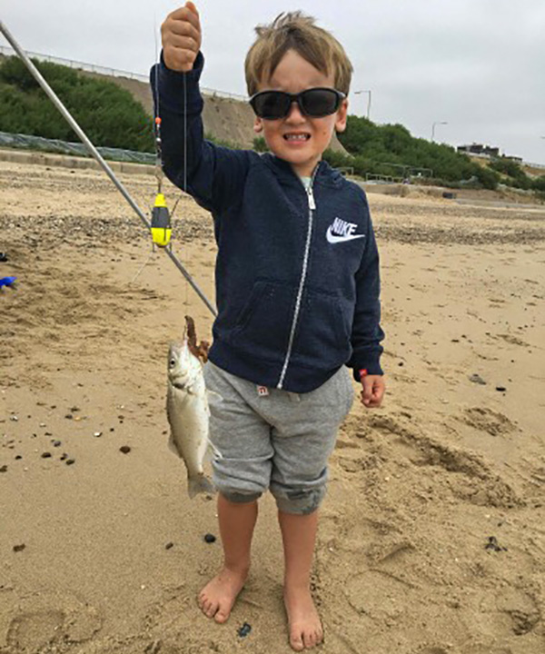 Young Oliver Rotchell with a bass