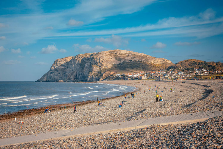 Anglers on Llandudno North Shore beach under Little Orme
