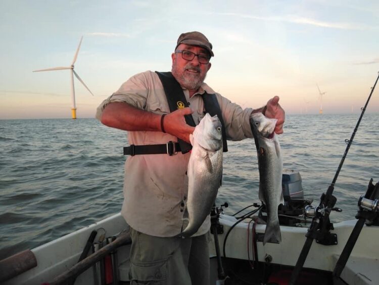 Alan Tipple with a brace of bass from the Gunfleet Sands