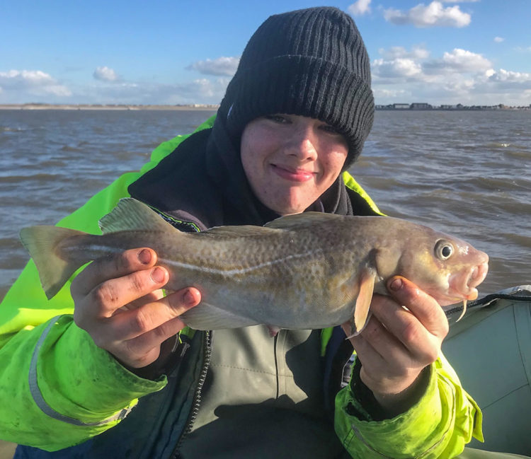 Liam Tighe with a boat caught codling